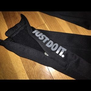 joggers by nike with logo detailing and zipper